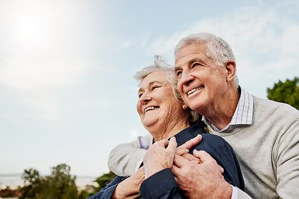 A senior couple embracing one another
