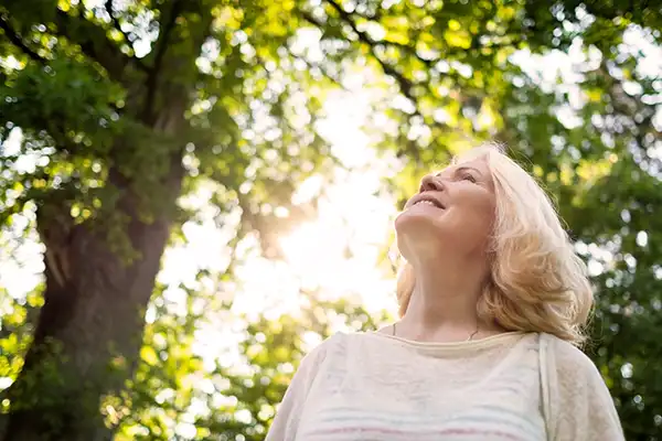 An older woman going for a hike in nature