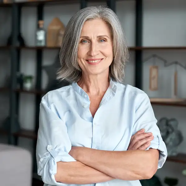 A woman with her sleeves rolled up smiling